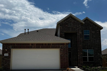 Rosenberg house for rent - A house with a white garage door and a brick facade.