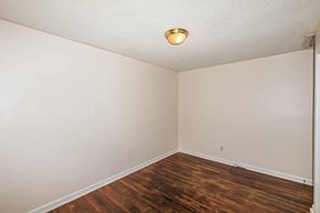 Jacksonville house for rent - A room with wooden floors and white walls.
