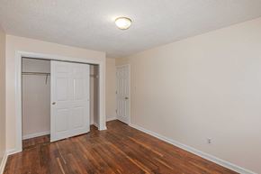 Jacksonville house for rent - A room with a white door and a wooden floor.