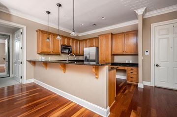 Murfreesboro apartment for rent - A kitchen with wooden cabinets and a black countertop.