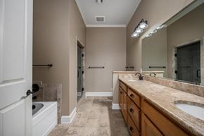 Murfreesboro apartment for rent - A bathroom with a marble countertop and a walk-in shower.