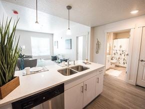Salt Lake City apartment for rent - A modern kitchen with a white countertop and stainless steel appliances.