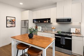 Seattle apartment for rent - A kitchen with a wooden table and stools.