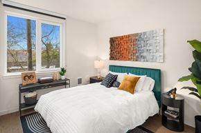 Seattle apartment for rent - A bedroom with a large bed and a painting on the wall.