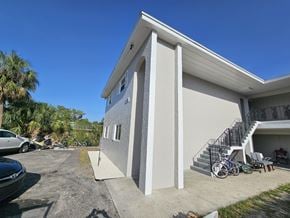 Fort Myers apartment for rent - A house with a white exterior and a black metal staircase.
