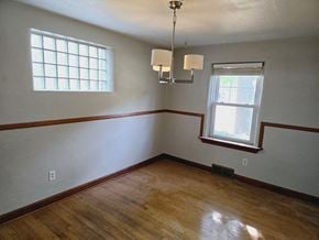 St. Louis house for rent - an empty room with a wooden floor and a window