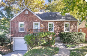 St. Louis house for rent - a red brick house with a white garage door