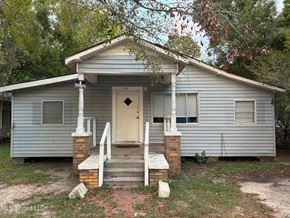 Gulfport house for rent - an old with a white door and stairs