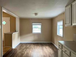 Gulfport house for rent - a kitchen with a hard wood floor and a window