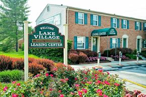Severn apartment for rent - a sign for the lake village leasing center in front of a brick building