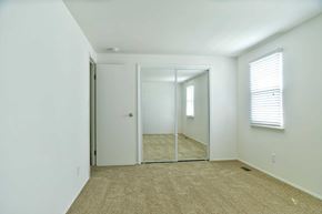 Severn apartment for rent - a bedroom with a mirror and a carpeted floor
