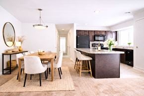 Linthicum apartment for rent - A kitchen with a black refrigerator and black appliances.