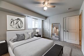 Baltimore apartment for rent - A bedroom with a large bed and a ceiling fan.