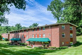 Baltimore apartment for rent - A red brick building with a green awning.