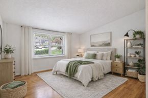 Baltimore apartment for rent - A bedroom with a large bed and a flat screen TV.