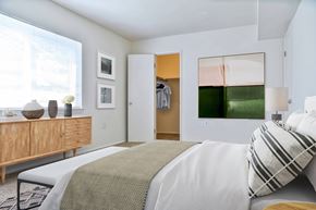 Frederick apartment for rent - A bedroom with a bed, a dresser, and a painting on the wall.
