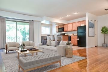 Owings Mills apartment for rent - A modern living room with a grey sofa and a wooden coffee table.