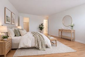 Owings Mills apartment for rent - A bedroom with a bed, a nightstand, a dresser, and a painting on the wall.
