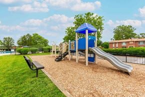 Owings Mills apartment for rent - A large swimming pool surrounded by trees and a ladder.