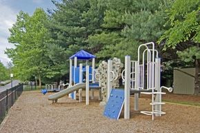 Owings Mills apartment for rent - A playground with a blue slide and a white and blue structure.
