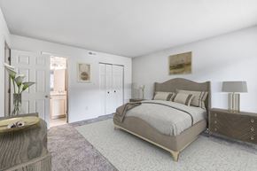 Sykesville apartment for rent - A bedroom with a large bed, a dresser, and a nightstand.