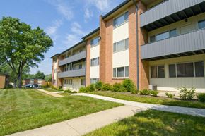 Baltimore apartment for rent - A grassy area in front of a building with a tree.