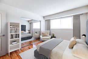 Baltimore apartment for rent - A bedroom with a large bed and a chair.