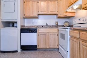 Frederick apartment for rent - a kitchen with white appliances and wooden cabinets