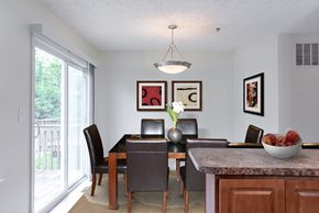Glen Burnie apartment for rent - A dining room with a table set for two and a bowl of fruit on the counter.