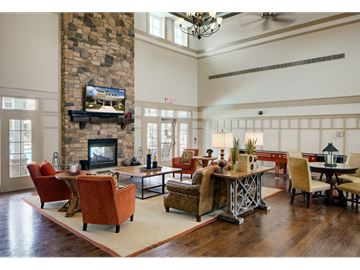 Aberdeen apartment for rent - A living room with a stone fireplace and a television above it.