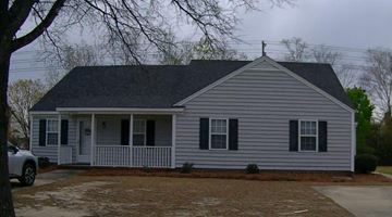 Wilson apartment for rent - a white house with black shutters and a front porch
