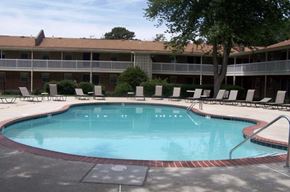 Newport News apartment for rent - a large swimming pool in front of a hotel building