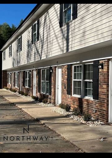 Belmont apartment for rent - a white house with black shuttered windows and a sidewalk