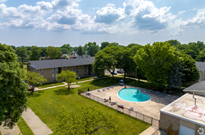 Westland apartment for rent - an aerial view of a swimming pool with trees and a building in the background