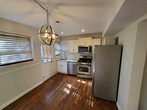Washington house for rent - a kitchen with stainless steel appliances and white cabinets