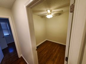 Washington house for rent - a bedroom with a ceiling fan and wood floors