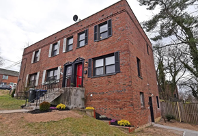 Washington house for rent - an old brick building with red doors and black windows