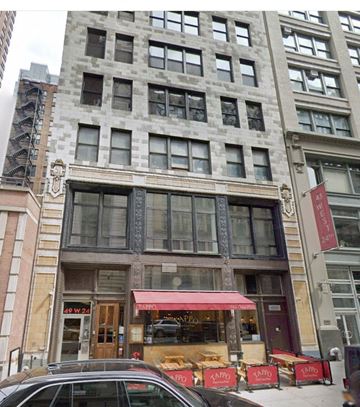New York apartment for rent - a building with a red awning on a city street