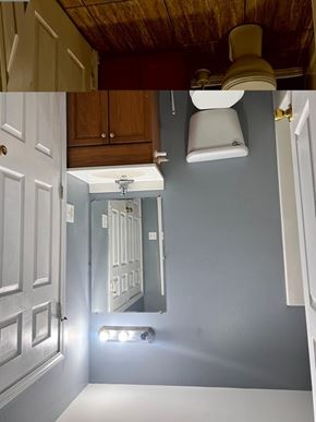 Gulfport apartment for rent - A bathroom with a white toilet and a mirror above it.