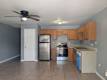 Gulfport apartment for rent - A kitchen with a refrigerator, oven, and cabinets.
