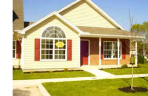 Pocomoke house for rent - a house with a yellow sign on the front of it
