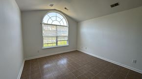 Pocomoke house for rent - an empty living room with a large window and tiled floors