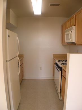 Washington apartment for rent - A kitchen with a refrigerator, stove, and microwave.