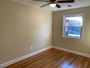 Washington apartment for rent - A room with a ceiling fan and a window.
