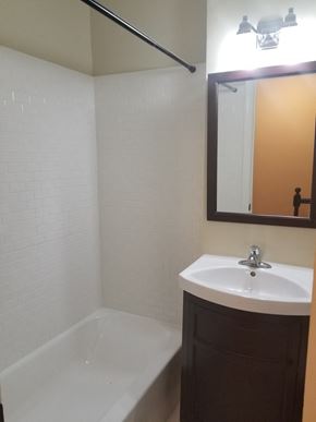 Washington apartment for rent - a small bathroom with a sink and a tub and a mirror