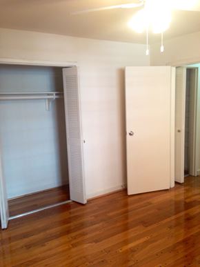 Washington apartment for rent - an empty living room with a closet and a hard wood floor