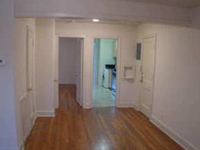 Washington apartment for rent - A room with wooden floors and white walls.