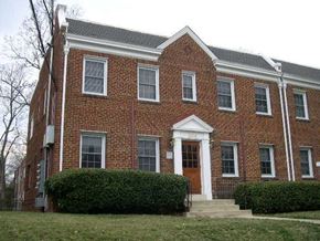 Washington apartment for rent - A red brick building with a white door and windows.