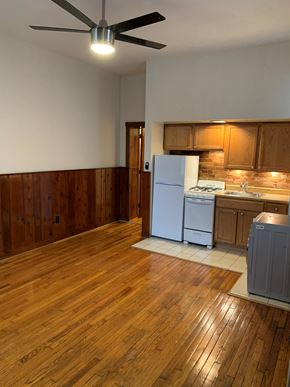 Washington apartment for rent - A kitchen with wooden floors and white appliances.