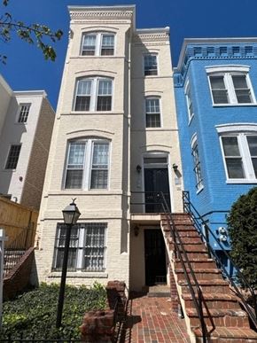 Washington apartment for rent - A white building with a black lamp post in front of it.